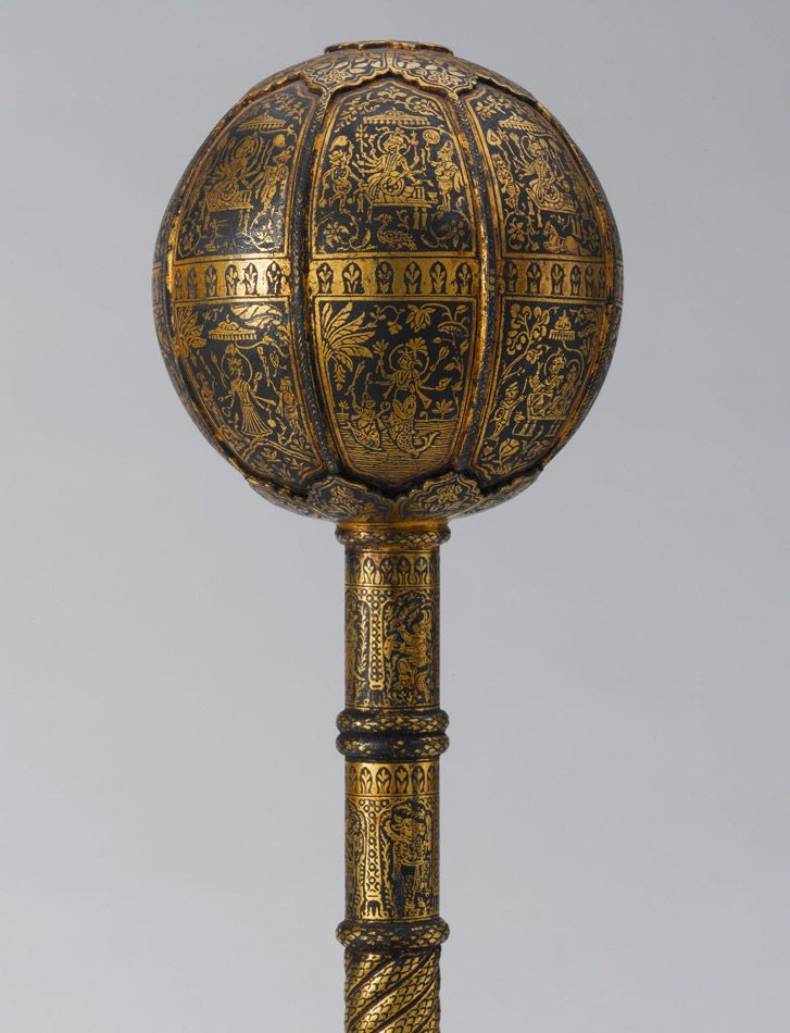 Mace with staff downward.